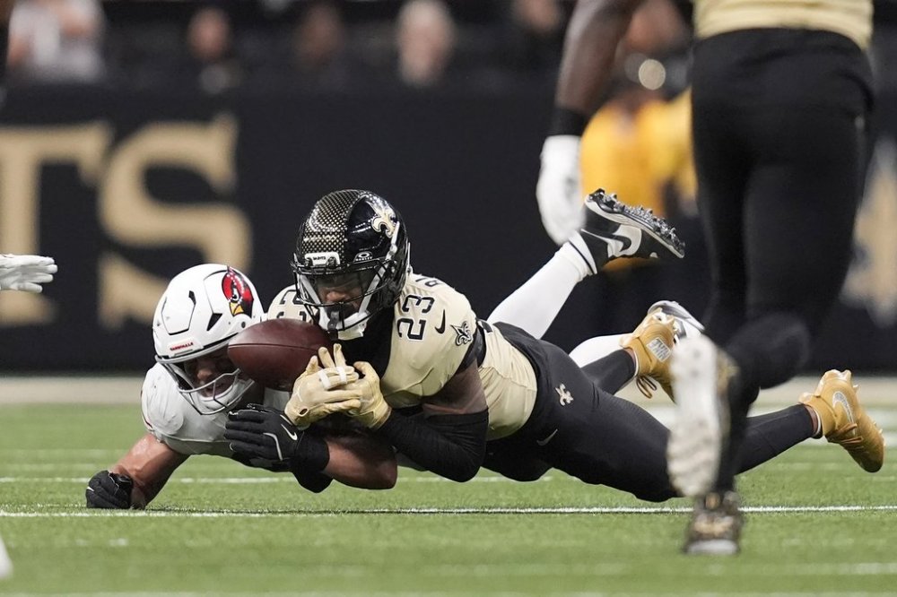 New Orleans Saints safety Julian Blackmon (23) is unable to intercept a pass intended for Arizona Cardinals tight end Trey McBride during the second half of an NFL football game Sunday, Sept. 7, 2025, in New Orleans. (AP Photo/Gerald Herbert)