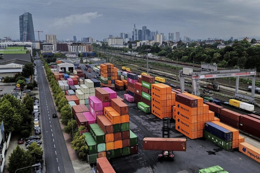 Containers are piled upon a cargo terminal in Frankfurt, Germany, Tuesday, Sept. 9, 2025. (AP Photo/Michael Probst)