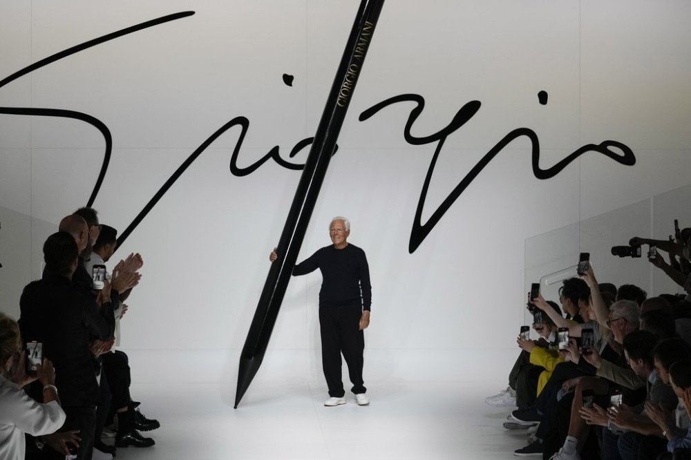 FILE -Designer Giorgio Armani receives applause at the end of the Giorgio Armani men's Spring Summer 2024 fashion show presented in Milan, Italy,, June 19, 2023. (AP Photo/Luca Bruno, File)