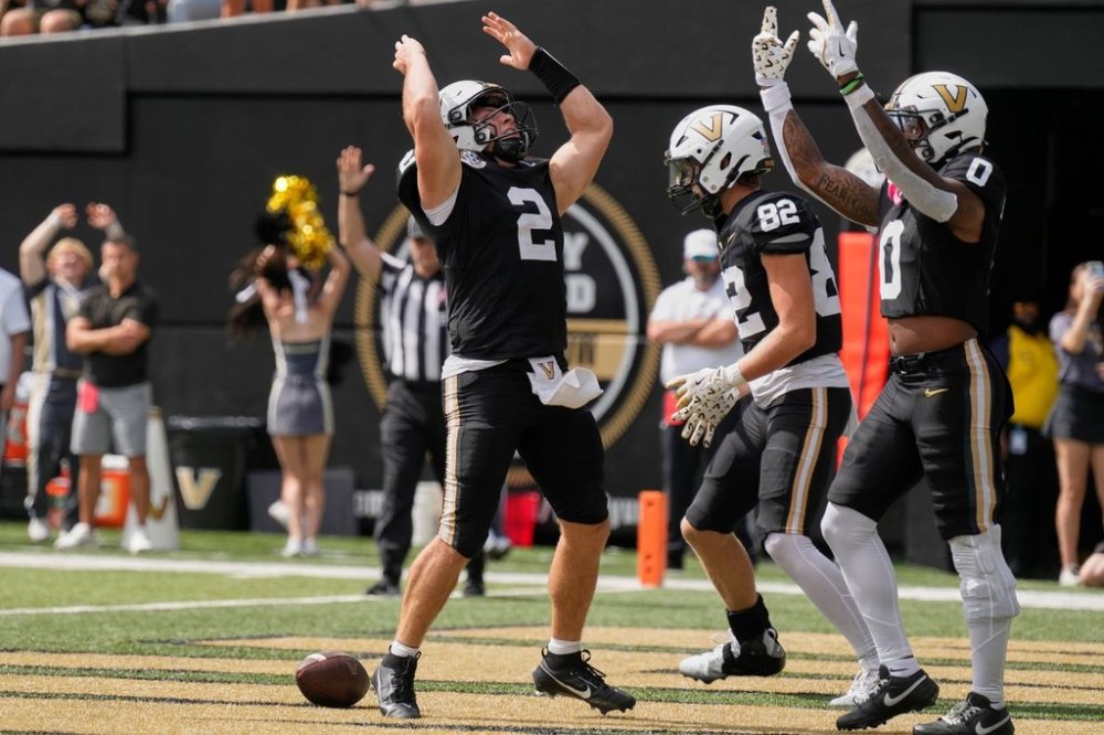 Vanderbilt quarterback Diego Pavia (2) celebrates his touchdown with wide receiver Junior Sherrill (0) during the first half of an NCAA college football game against Utah State, Saturday, Sept. 27, 2025, in Nashville, Tenn. (AP Photo/George Walker IV)