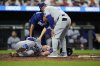 Los Angeles Dodgers' Dalton Rushing, bottom left, reacts after an injury during the sixth inning of a baseball game against the Baltimore Orioles, Friday, Sept. 5, 2025, in Baltimore. (AP Photo/Stephanie Scarbrough)