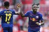 Leipzig's Johan Bakayoko, right, celebrates after scoring the opening goal during the German Bundesliga soccer match between FSV Mainz 05 and RB Leipzig in Mainz, Germany, Saturday, Sept. 13, 2025. (Uwe Anspach/dpa via AP)