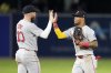 Boston Red Sox's Trevor Story (10) and Ceddanne Rafaela celebrate after the team defeated the Tampa Bay Rays during a baseball game Saturday, Sept. 20, 2025, in Tampa, Fla. (AP Photo/Chris O'Meara)