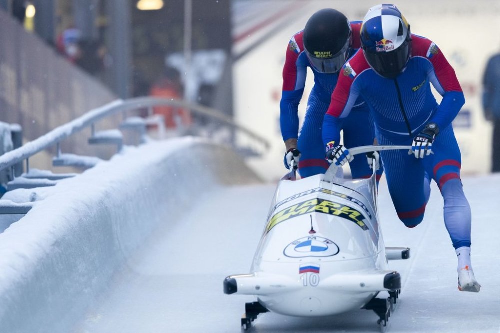 FILE - Rostislav Gaitiukevich and Mikhail Mordasov, from Russia, push at the start of the men's two-man bobsleigh World Cup race in Igls, near Innsbruck, Austria, Saturday, Nov. 27, 2021. (AP Photo/Lisa Leutner, File)