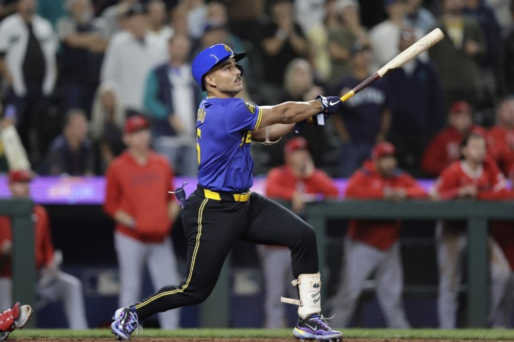 Seattle Mariners' Harry Ford hits a walkoff sacrifice fly against the Los Angeles Angels during the 12th inning of a baseball game Thursday, Sept. 11, 2025, in Seattle. (AP Photo/John Froschauer)