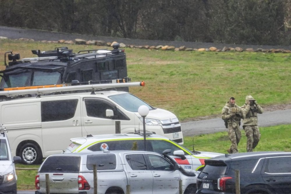 Victorian state Police gather at a staging area at Feathertop Winery in Porepunkah, Australia, Aug. 27, 2025, during a search for a fugitive believed to be involved in the shooting of two police officers. (Simon Dallinger/AAP Image via AP)
