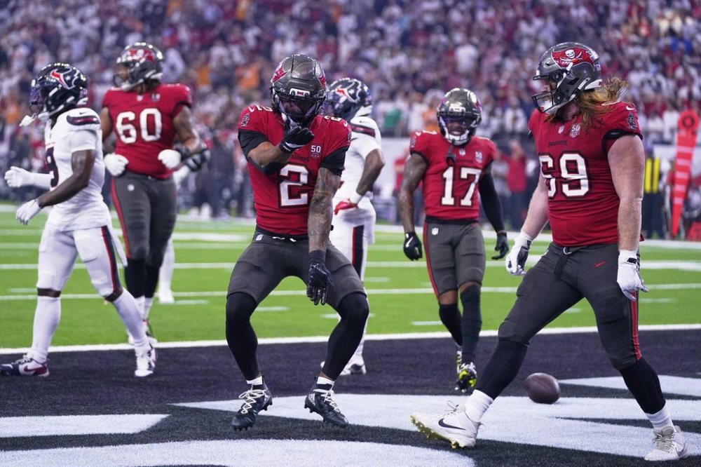Tampa Bay Buccaneers wide receiver Emeka Egbuka (2) Sterling Shepard (17) and Cody Mauch (69) celebrate after Egbuka scored a touchdown in the first half of an NFL football game against the Houston Texans Monday, Sept. 15, 2025, in Houston, Texas. (AP Photo/Eric Christian Smith)