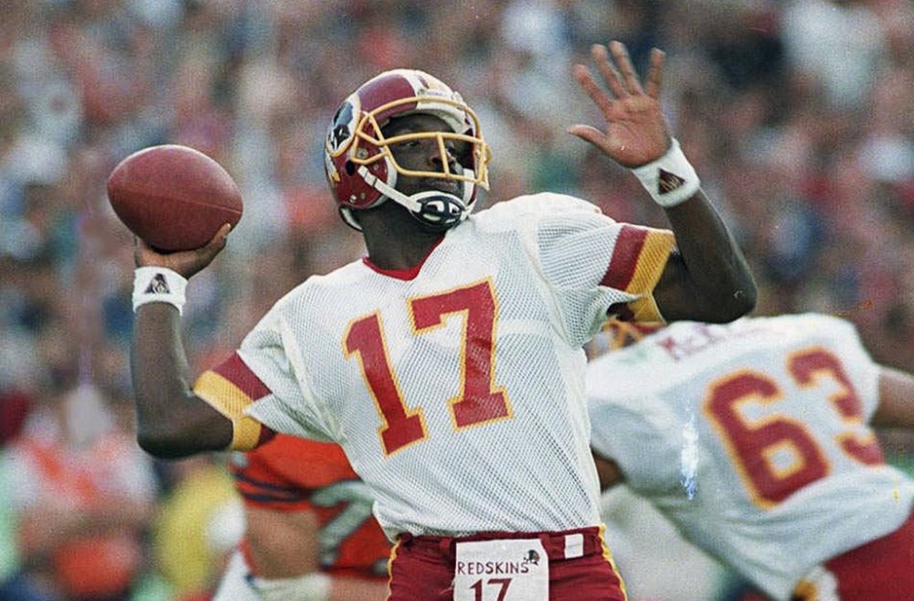 FILE - Washington Redskins quarterback Doug Williams prepares to let go of a pass during first quarter of Super Bowl XXII against the Denver Broncos in San Diego, Jan. 31, 1988. (AP Photo/Elise Amendola, File)