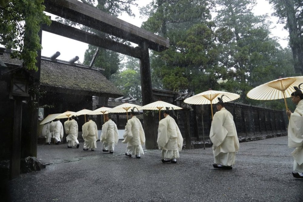 Shinto priests march into the main palace of Toyoukedaijingu, also known as Geku, or the outer sanctuary, of the Ise Jingu shrine complex as they begin Yamaguchisai, a kickoff ceremony of Shikinen Sengu, concluding in 2033, in Ise, central Japan, May 2, 2025. (AP Photo/Hiro Komae)