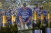 Toronto Blue Jays manager John Schneider, centre, celebrates with players in the clubhouse after their baseball game against the Kansas City Royals, in Kansas City, Mo., Sunday, Sept. 21, 2025. THE CANADIAN PRESS/AP-Charlie Riedel