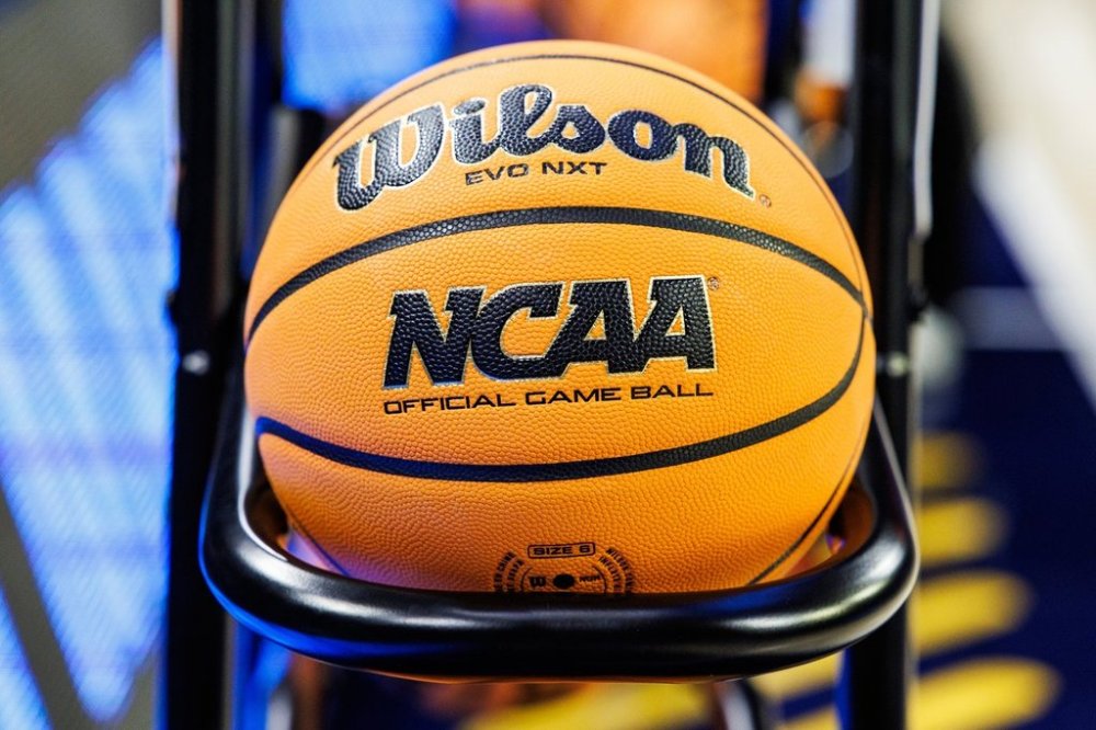 FILE - A basketball with an NCAA logo rests on the rack prior to a first-round college basketball game in the NCAA Tournament between Iowa State and Michigan, Friday, March 21, 2025, in South Bend, Ind. (AP Photo/John Mersits)