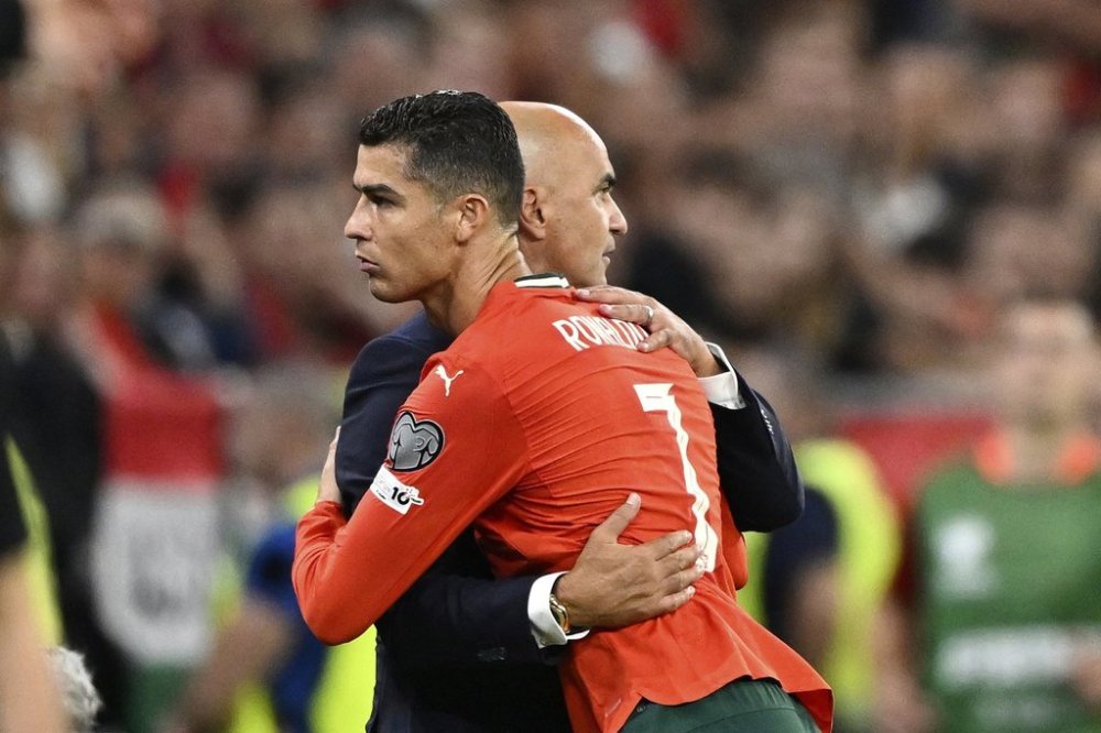 Portugal's Cristiano Ronaldo embraces Portugal coach Roberto Martinez after being substituted during a World Cup 2026 group F qualifying soccer match between Hungary and Portugal at the Puskas Arena in Budapest, Tuesday, Sept. 9, 2025. (AP Photo/Denes Erdos)