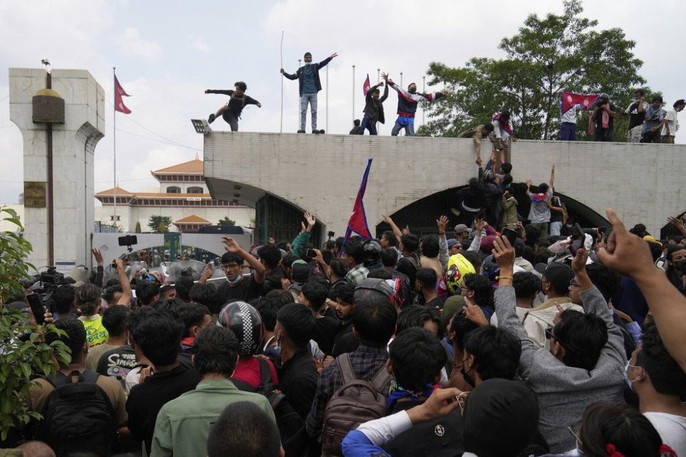 Protesters shout slogans as they gather outside the Parliament building in Kathmandu, Nepal, Monday, Sept. 8, 2025. (AP Photo/Niranjan Shrestha)