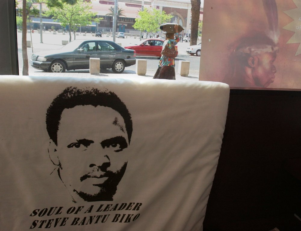 FILE - A pillowcase features a printed portrait of a Black Consciousness Movement leader, Steve Biko, in the window of the African-focused Xarra Books, in downtown Johannesburg, Sept 10, 2007. (AP Photo/Denis Farrell, File)