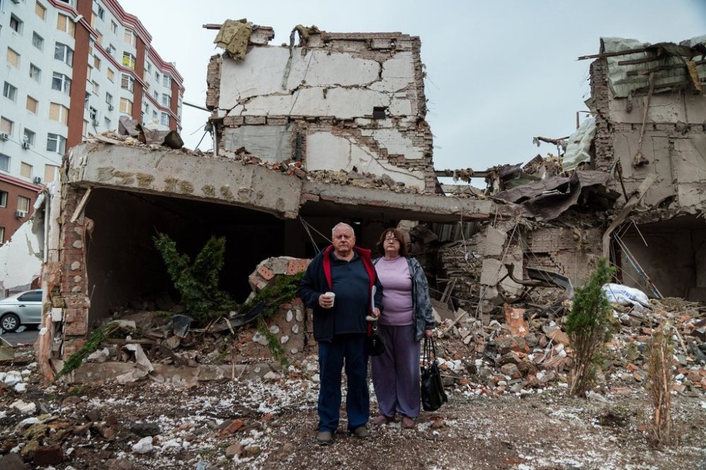 Mykola Pastukh, 67, with his wife Oksana Pastukh, 58, stand next to their house destroyed in a Russian attack in Kyiv, Ukraine, on Monday, Sept. 29, 2025. (AP Photo/Vasilisa Stepanenko)