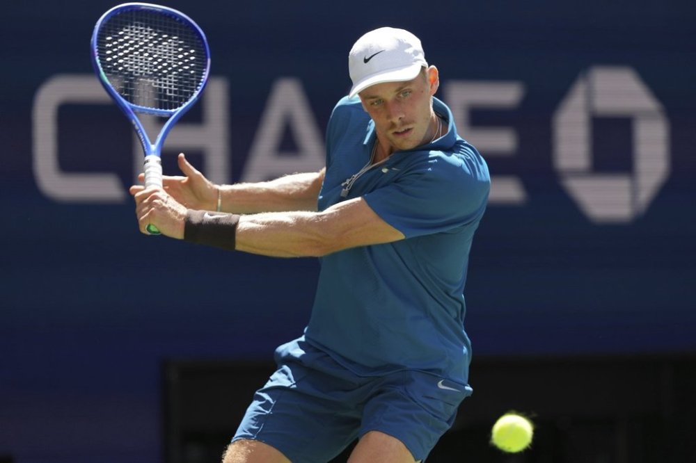 Denis Shapovalov, of Canada, returns a shot against Jannik Sinner, of Italy, during the third round of the U.S. Open tennis championships, Saturday, Aug. 30, 2025, in New York. (AP Photo/Kirsty Wigglesworth)