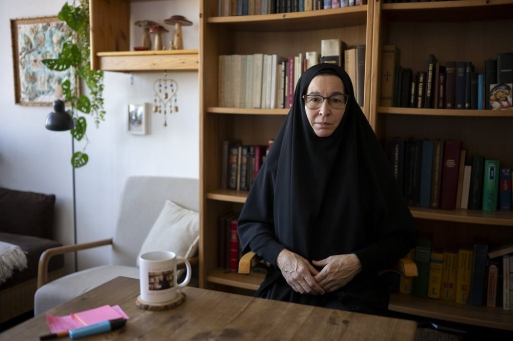 Sister Vassa Larin, a prominent American Orthodox nun, public speaker and YouTube presenter, poses for a portrait for the Associated Press in her room before recording one of her videos in Vienna, Austria, on Wednesday, Sept 3. 2025. (AP Photo/Denes Erdos)