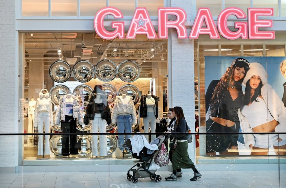 People walk by a Garage clothing retail store in Montreal, Friday, Nov. 15, 2024. THE CANADIAN PRESS/Graham Hughes.