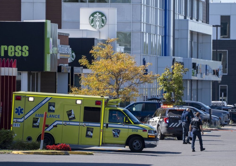 Police and paramedics respond to a shooting in Laval, Que., on Wednesday, Oct. 1, 2025. THE CANADIAN PRESS/Christinne Muschi