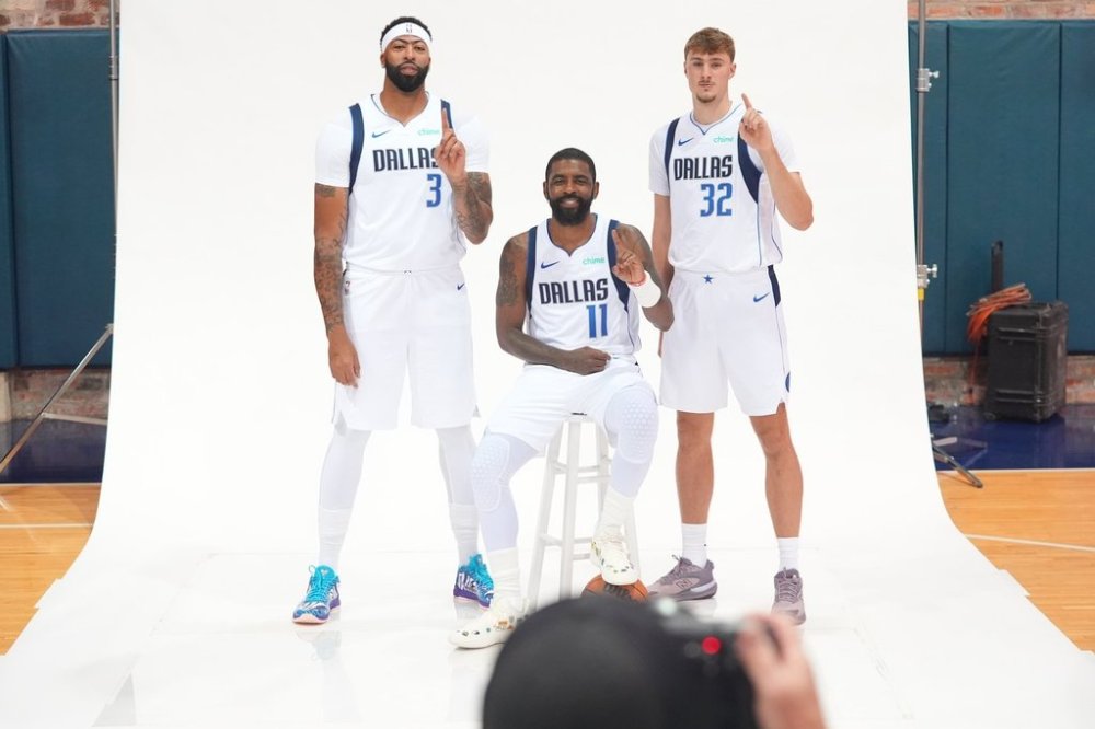 Dallas Mavericks forward Cooper Flagg (32), guard Kyrie Irving (11) and forward Anthony Davis (3) pose for a photo during the NBA basketball team's media day in Dallas, Monday, Sept. 29, 2025. (AP Photo/LM Otero)
