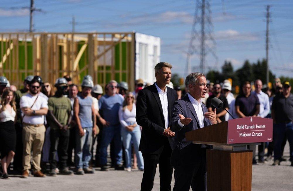 Prime Minister Mark Carney participates in an announcement for the new federal agency Build Canada Homes with Minister of Housing and Infrastructure Gregor Robertson, in Ottawa, on Sunday, Sept. 14, 2025. The CEO of Caivan Homes said the homes at the announcement were prototype builds and that it wasn't meant to be misunderstood as a permanent housing development site. THE CANADIAN PRESS/Justin Tang