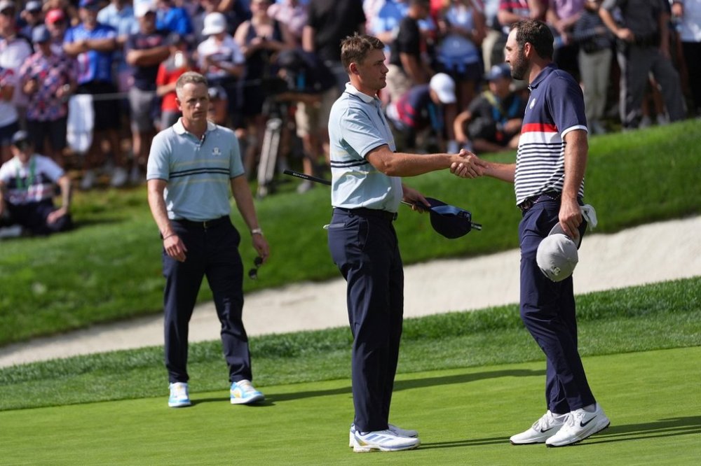 Europe's Ludvig Åberg greets United States' Scottie Scheffler after Europe won on the 15th hole at Bethpage Black golf course during the Ryder Cup golf tournament, Friday, Sept. 26, 2025, in Farmingdale, N.Y.(AP Photo/Lindsey Wasson)