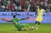 Turkey's goalkeeper Ugurcan Cakir, left, blocks a shot by Spain's Nico Williams during a World Cup qualifying round Group E soccer match between Turkey and Spain at Konya Buyuksehir stadium, in Konya, Turkey, Sunday, Sept. 7, 2025. (AP Photo/Khalil Hamra)