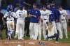 Los Angeles Dodgers' Clayton Kershaw, center, congratulates members of his team after the Dodgers defeated the San Francisco Giants in a baseball game Thursday, Sept. 18, 2025, in Los Angeles. (AP Photo/Mark J. Terrill)