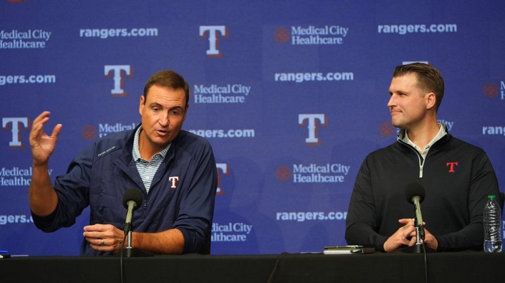 Texas Rangers president of baseball operations Chris Young, left, speaks as general manager Ross Fenstermaker looks on during an end of regular season baseball news conference, Friday, Oct. 3, 2025, in Arlington, Texas. (AP Photo/LM Otero)
