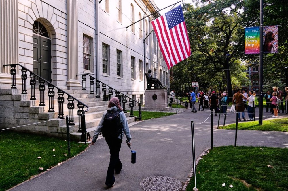A woman walks through Harvard Yard at Harvard University, Tuesday, Sept. 30, 2025, in Cambridge, Mass. (AP Photo/Charles Krupa)