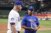 Texas Rangers manager Bruce Bochy, left, presents second baseman Marcus Semien with the Heart & Hustle award before a baseball game against the Los Angeles Angels, Wednesday, Aug. 27, 2025, in Arlington, Texas. (AP Photo/Tony Gutierrez)