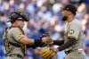 San Diego Padres' Robert Suarez and Freddy Fermin celebrate after Game 2 of a National League wild card baseball game against the Chicago Cubs Wednesday, Oct. 1, 2025, in Chicago. (AP Photo/Erin Hooley)