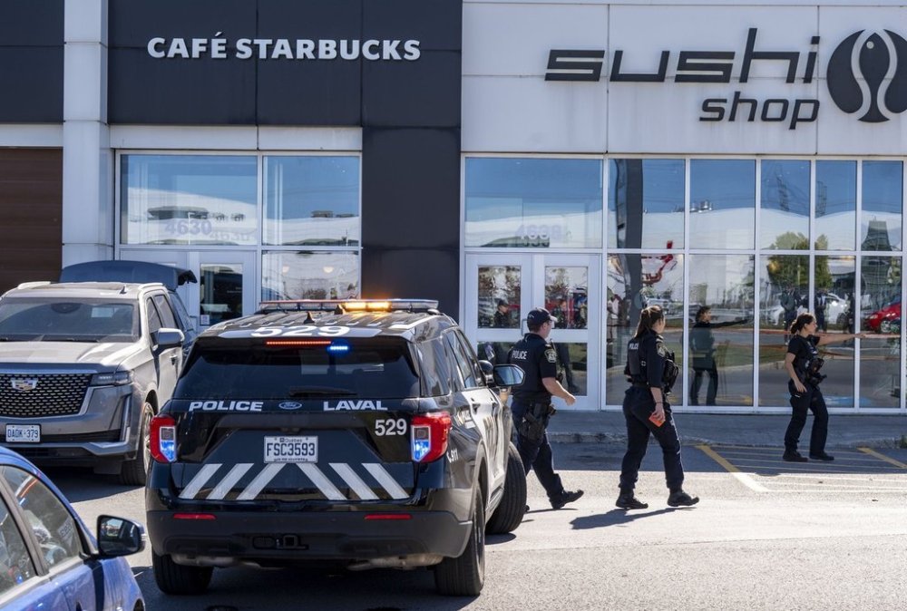 Laval Police respond to a shooting in Laval, Que., on Wednesday, Oct. 1, 2025. THE CANADIAN PRESS/Christinne Muschi
