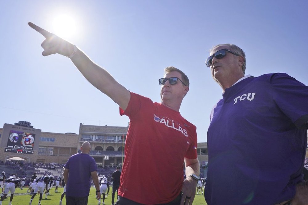 FILE - SMU head coach Rhett Lashlee, left, and TCU head coach Sonny Dykes chat before an NCAA college football game Saturday, Sept. 23, 2023, in Fort Worth, Texas. (AP Photo/LM Otero, File)