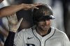Tampa Bay Rays' Brandon Lowe celebrates in the dugout after his solo home run off Boston Red Sox pitcher Steven Matz during the sixth inning of a baseball game Sunday, Sept. 21, 2025, in Tampa, Fla. (AP Photo/Chris O'Meara)