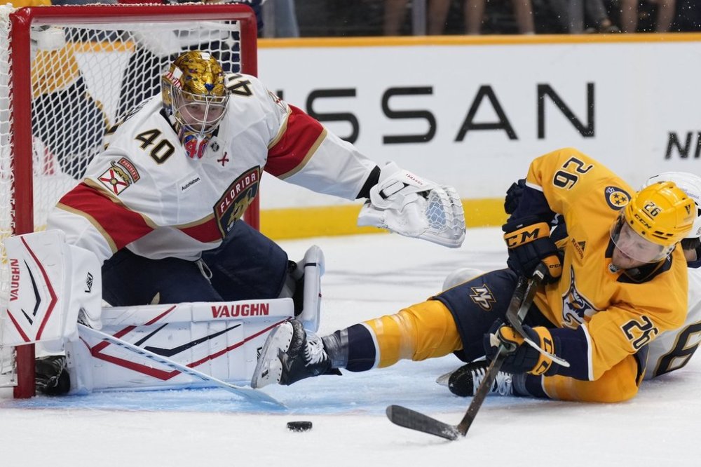 Florida Panthers goaltender Daniil Tarasov (40) blocks a shot on goal by Nashville Predators forward Daniel Carr (26) during the second period of an NHL preseason hockey game Sunday, Sept. 21, 2025, in Nashville, Tenn. (AP Photo/George Walker IV)