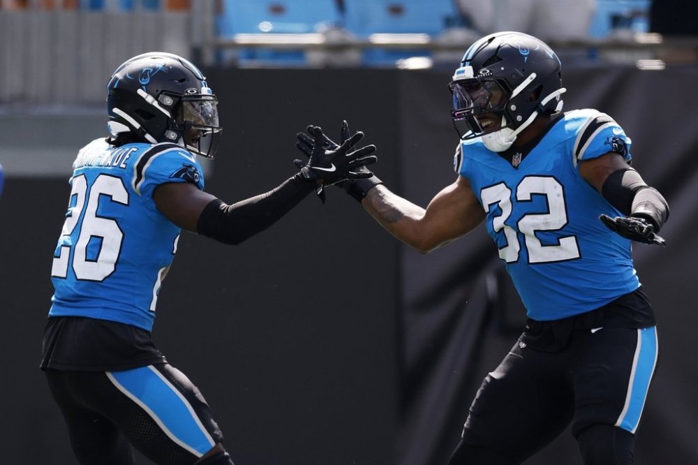 Carolina Panthers cornerback Chau Smith-Wade celebrates after scoring on an interception with linebacker Trevin Wallace against the Atlanta Falcons during the second half of an NFL football game, Sunday, Sept. 21, 2025, in Charlotte, N.C. (AP Photo/Rusty Jones)