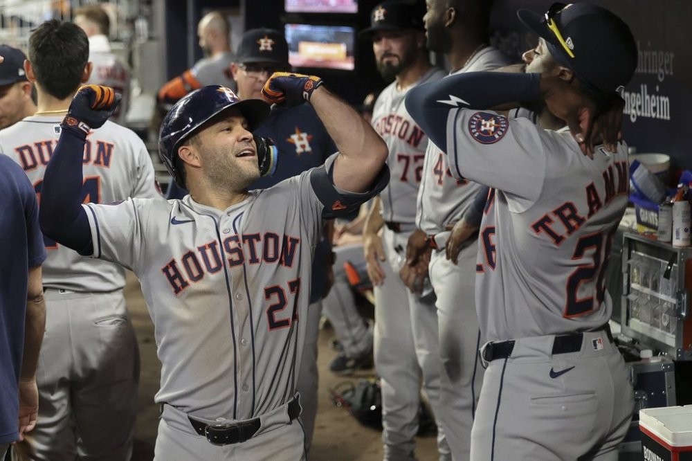 Houston Astros' Jose Altuve, left, flexes in the dugout after hitting a solo home run in the sixth inning of a baseball game against the Atlanta Braves, Friday, Sept. 12, 2025, in Atlanta. (AP Photo/Colin Hubbard)