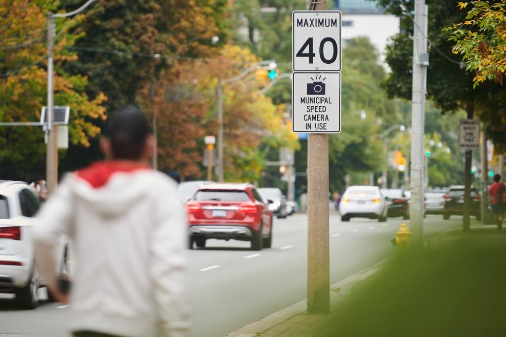 Vehicles pass a sign advising drivers of an upcoming speed camera in Toronto, on Wednesday, Sept. 24, 2025. THE CANADIAN PRESS/Sammy Kogan
