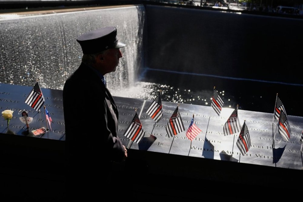 William Staudt, a firefighter that worked at Ground Zero on the day of the attacks, looks over a reflecting pool during a ceremony to mark the 24th anniversary of the 9/11 attacks, Thursday, Sept. 11, 2025, in New York. (AP Photo/Seth Wenig)