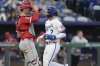 Kansas City Royals' Bobby Witt Jr. (7) crosses the plate past Los Angeles Angels catcher Logan O'Hoppe to score on a sacrifice fly by Vinnie Pasquantino during the third inning of a baseball game Tuesday, Sept. 2, 2025, in Kansas City, Mo. (AP Photo/Charlie Riedel)