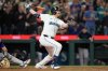 Seattle Mariners' Cal Raleigh watches his 60th home run during the eighth inning of a baseball game against the Colorado Rockies, Wednesday, Sept. 24, 2025, in Seattle. (AP Photo/Ryan Sun)
