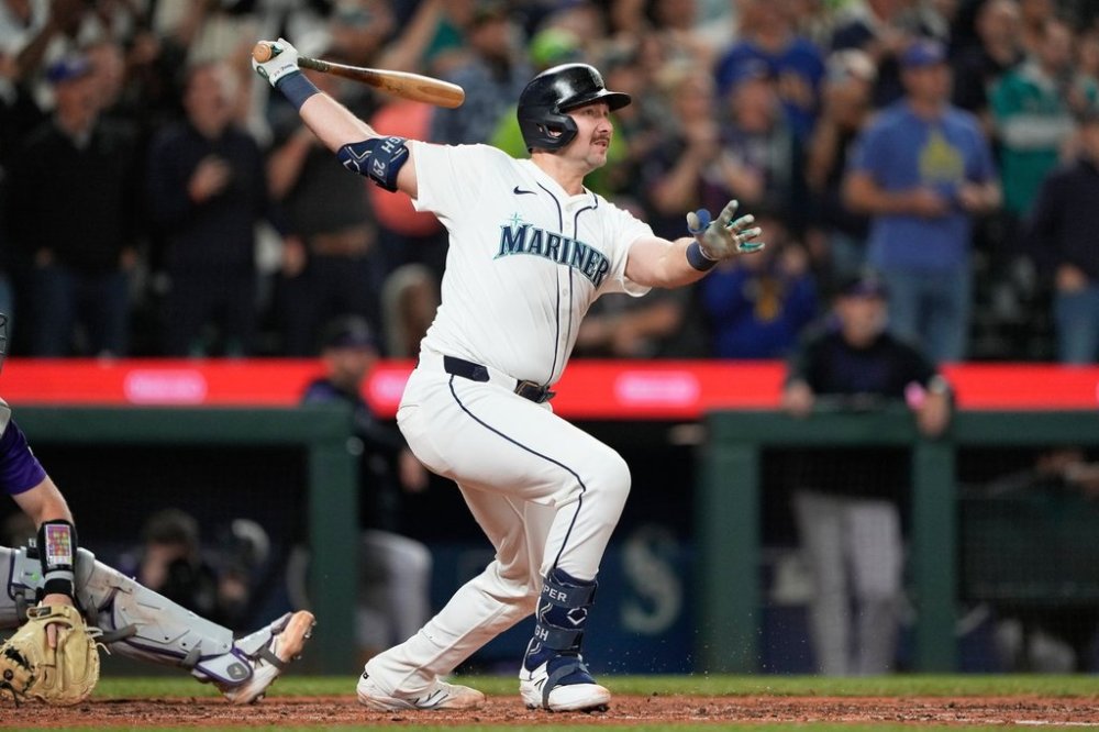 Seattle Mariners' Cal Raleigh watches his 60th home run during the eighth inning of a baseball game against the Colorado Rockies, Wednesday, Sept. 24, 2025, in Seattle. (AP Photo/Ryan Sun)