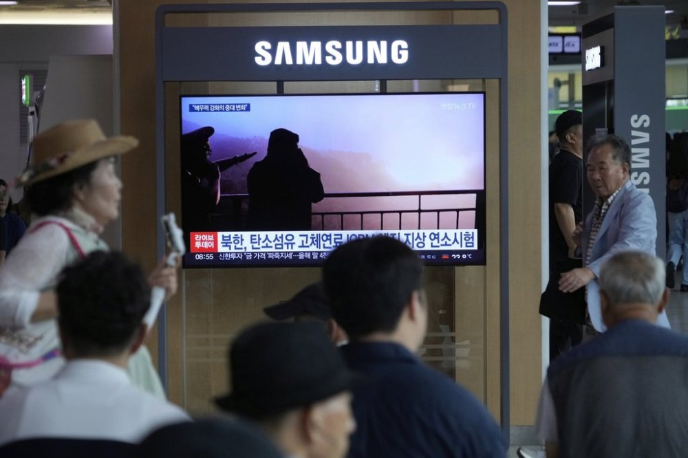A TV screen shows an image of North Korean leader Kim Jong Un, second from right, supervising a test of a new rocket engine during a news program at the Seoul Railway Station in Seoul, South Korea, Tuesday, Sept. 9, 2025. (AP Photo/Ahn Young-joon)