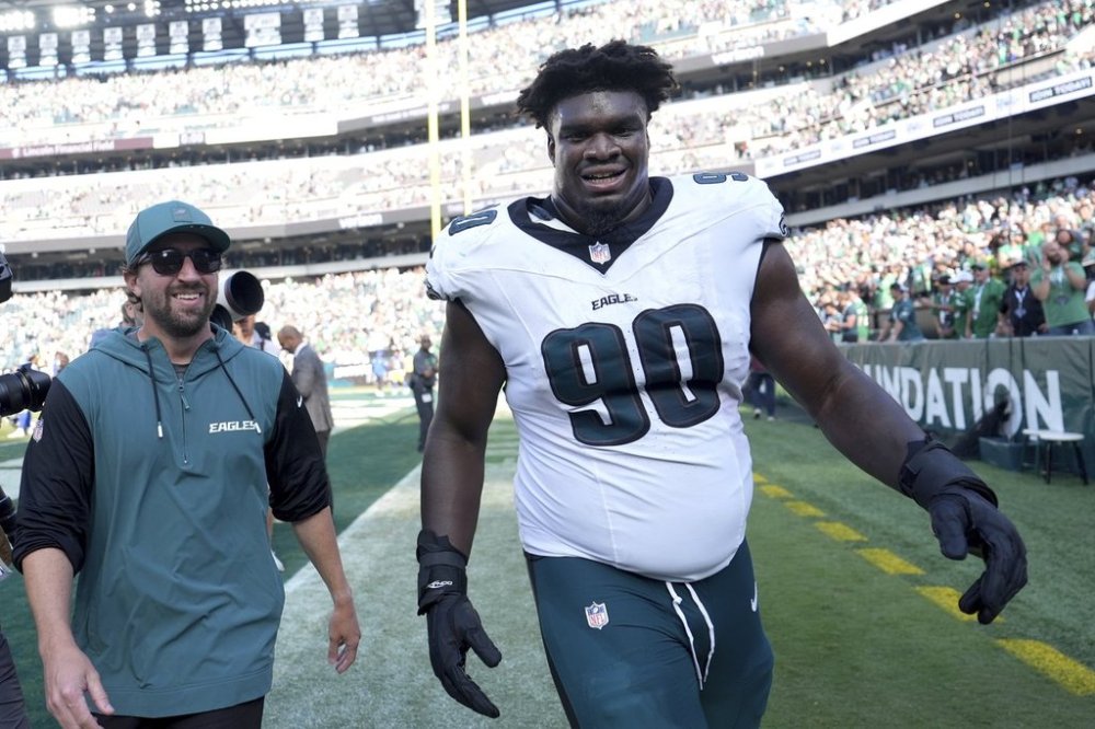 Philadelphia Eagles defensive tackle Jordan Davis (90) celebrates after blocking a field goal attempt and running it back for a touchdown as time expired in an NFL football game against the Los Angeles Rams Sunday, Sept. 21, 2025, in Philadelphia. (AP Photo/Matt Slocum)