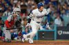 Los Angeles Dodgers' Shohei Ohtani follows through on an RBI single during the sixth inning in Game 2 of the National League Wild Card baseball playoff series against the Cincinnati Reds, Wednesday, Oct. 1, 2025, in Los Angeles. (AP Photo/Mark J. Terrill)