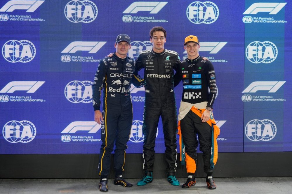Frome the left, second-placed Red Bull driver Max Verstappen of the Netherlands, first-placed Mercedes driver George Russell of Britain and third-placed McLaren driver Lando Norris of Britain pose after the qualifying for the Singapore Formula One Grand Prix at the Marina Bay Street Circuit in Singapore, Saturday, Oct. 4, 2025. (AP Photo/Vincent Thian)