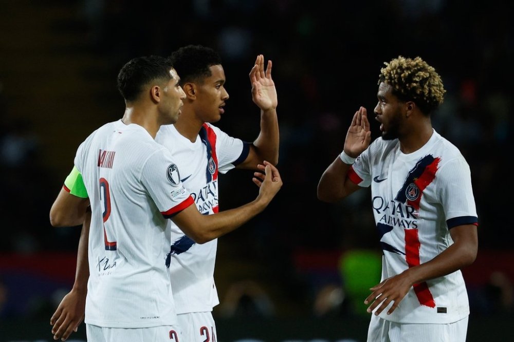PSG's Senny Mayulu, center, celebrates with teammates after scoring his side's opening goal during the Champions League opening phase soccer match between Barcelona and Paris Saint-Germain at the Lluis Companys Olympic Stadium in Barcelona, Spain, Wednesday, Oct. 1, 2025. (AP Photo/Joan Monfort)