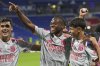 Lyon's Khalis Merah, right, and Lyon's Enzo Molebe, centre, celebrate after the French League One soccer match between Olympique Lyon and Angers at Groupama stadium in Decines, outside Lyon, France, Friday, Sept. 19, 2025. (AP Photo/Laurent Cipriani)