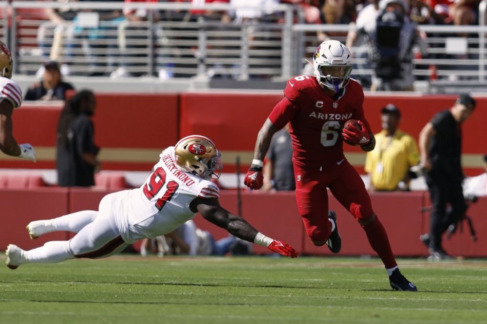 Arizona Cardinals running back James Conner, right, avoids a tackle by San Francisco 49ers defensive tackle Sam Okuayinonu during the second half of an NFL football game Sunday, Sept. 21, 2025, in Santa Clara, Calif. (AP Photo/Sergio Estrada)